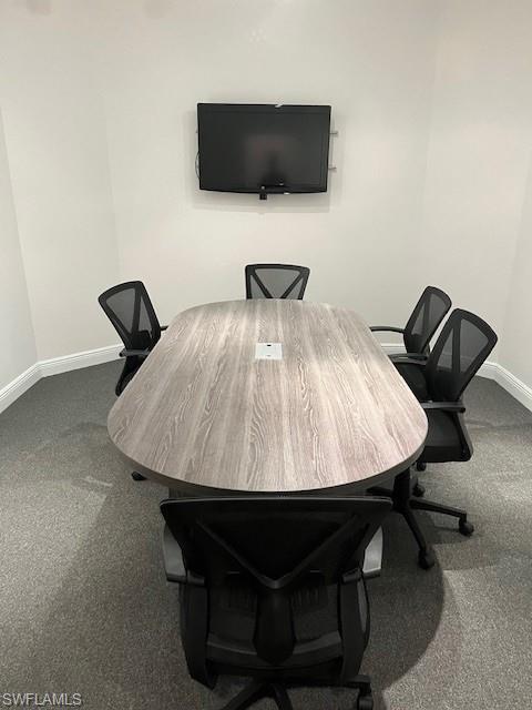 Carpeted office with baseboards