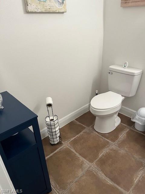 Half bathroom with baseboards and tile patterned floors