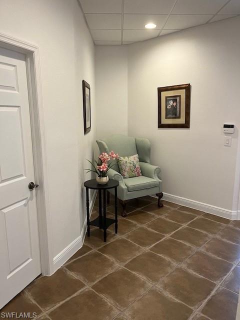 Living area featuring a drop ceiling and recessed lighting