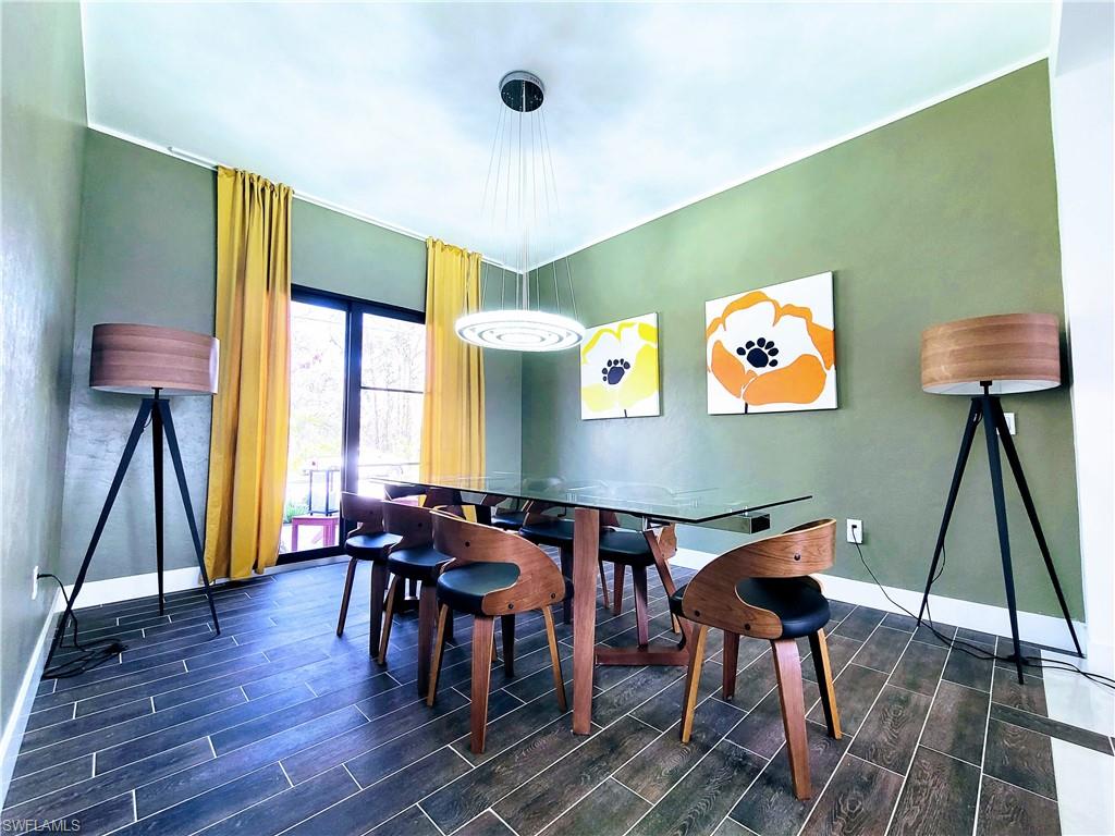 Dining room featuring dark wood-look tile flooring