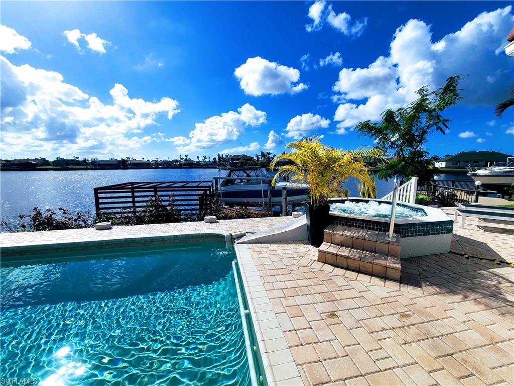 View of pool featuring a water view and a patio