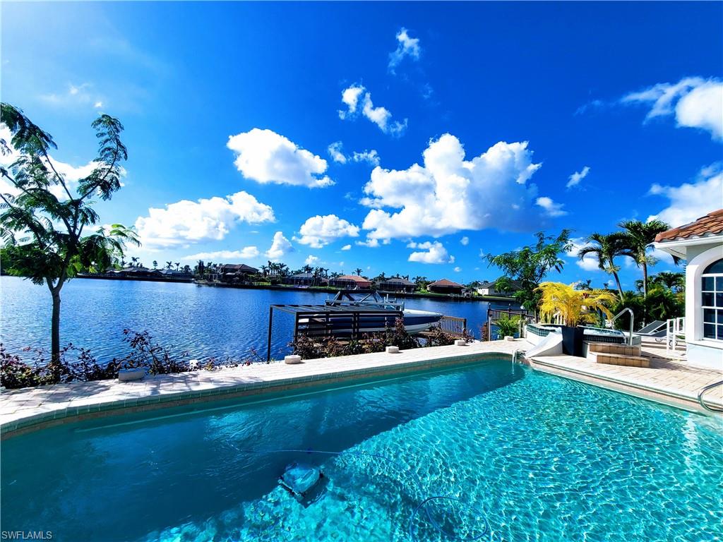 View of pool with a water view