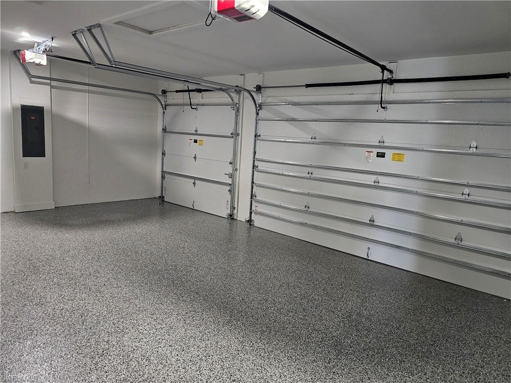 Garage with electric panel and a garage door opener