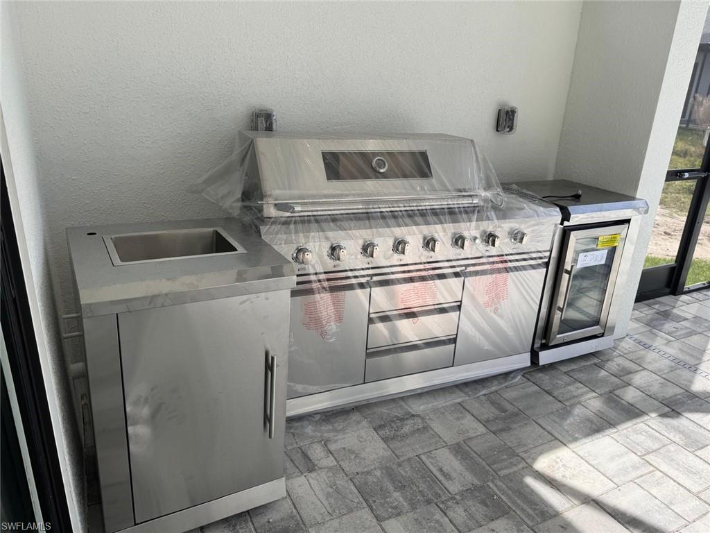 View of patio featuring a grill and an outdoor kitchen