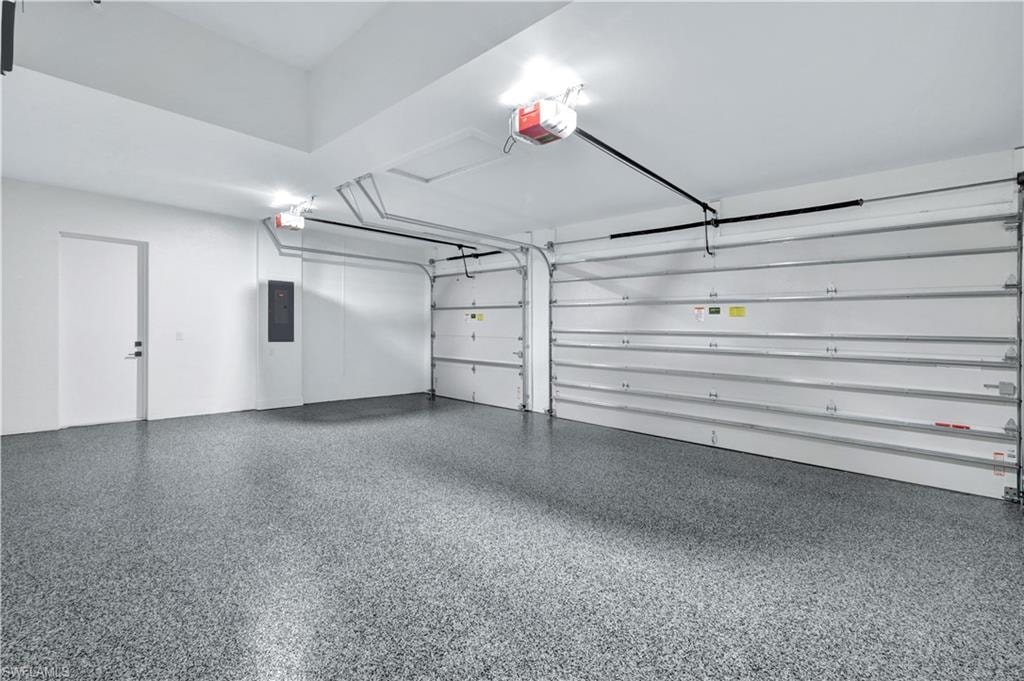 Garage with electric panel and a garage door opener