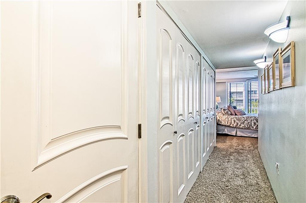 Bedroom with light carpet, crown molding, access to outside, a ceiling fan, and floor to ceiling windows