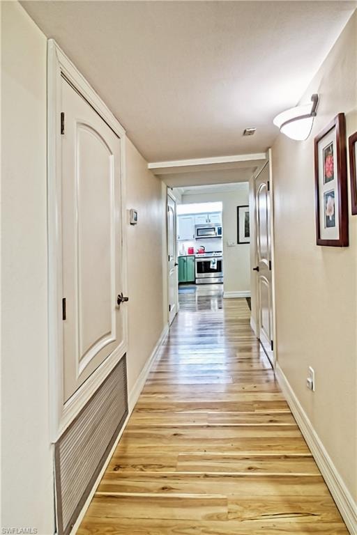 Living area with crown molding, a ceiling fan, light wood finished floors, and a desk
