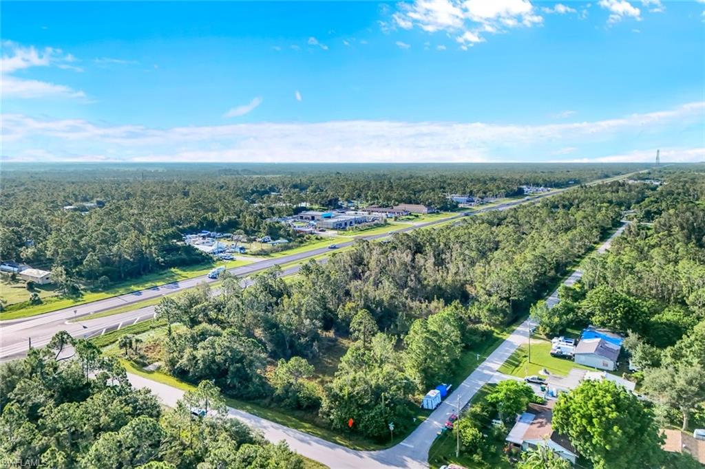Aerial overview of property's location with a heavily wooded area