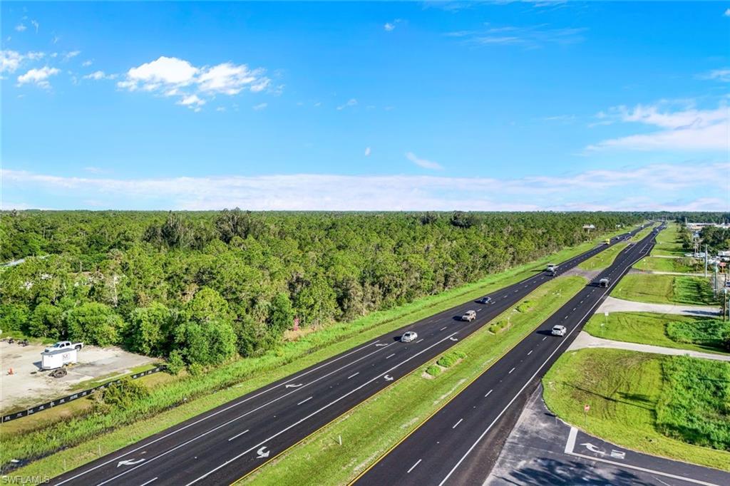 Drone / aerial view of a highway and a heavily wooded area