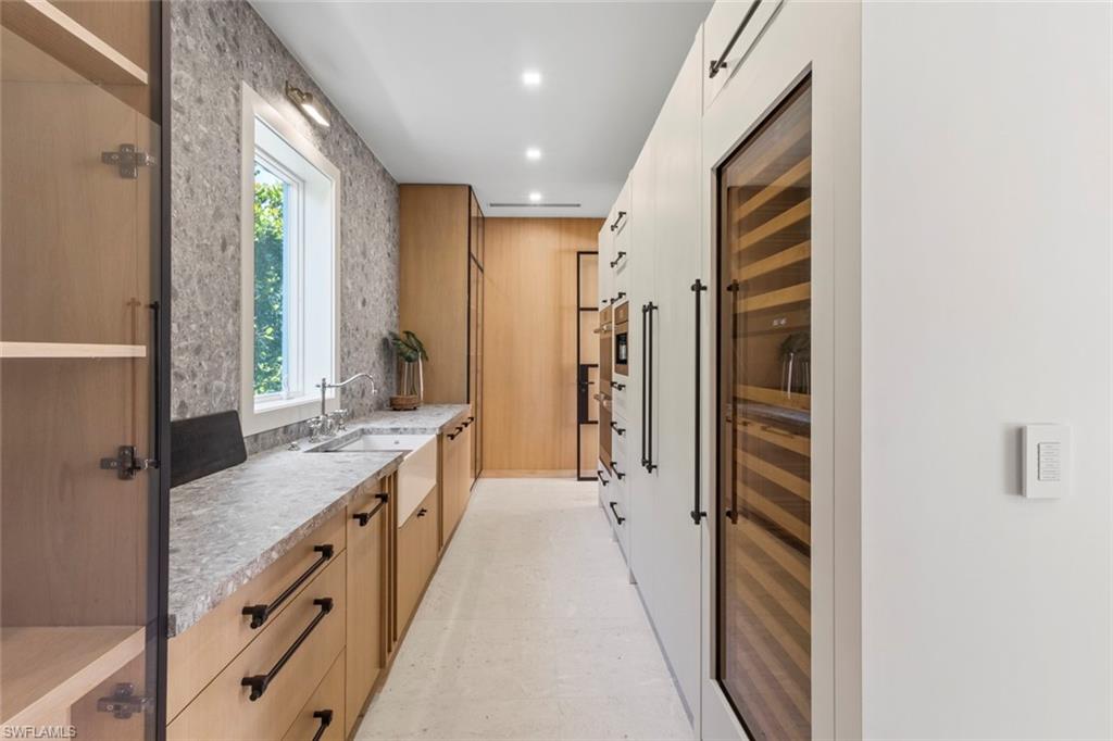 Bathroom with vanity, beverage cooler, and recessed lighting