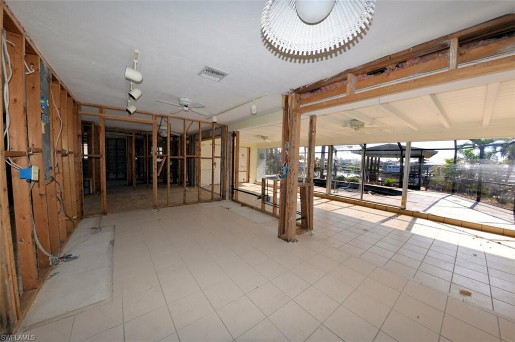 Large Florida Room with sliders to pool and dock