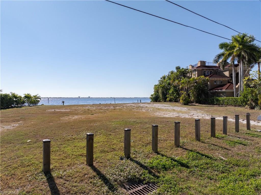 View of green lawn with a water view
