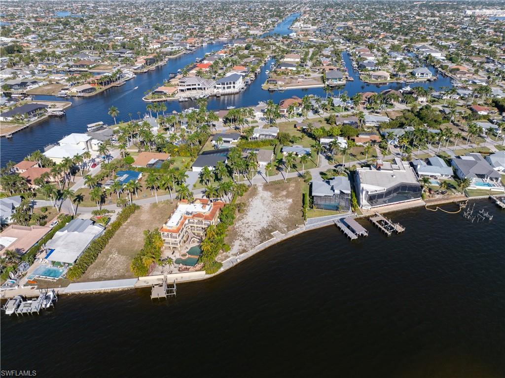 Aerial overview of property's location featuring nearby suburban area and a large body of water
