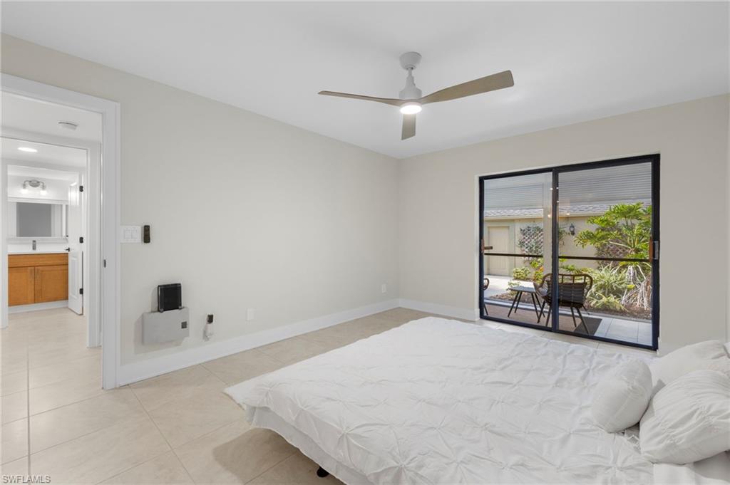 Bedroom featuring access to outside, ceiling fan, and light tile patterned floors