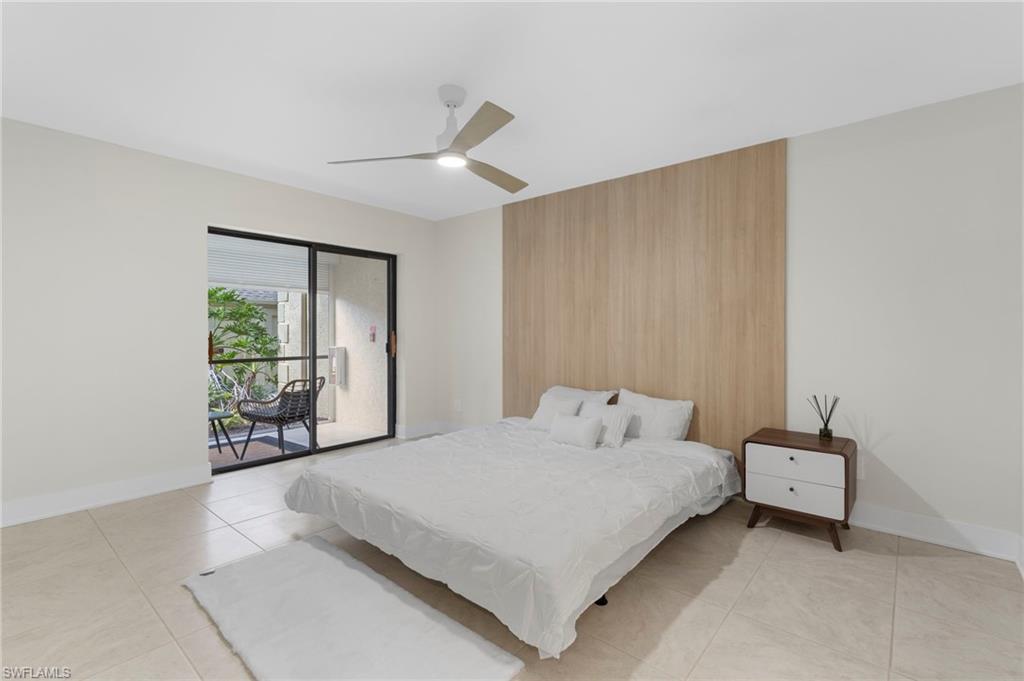 Bedroom featuring light tile patterned floors, ceiling fan, and access to exterior