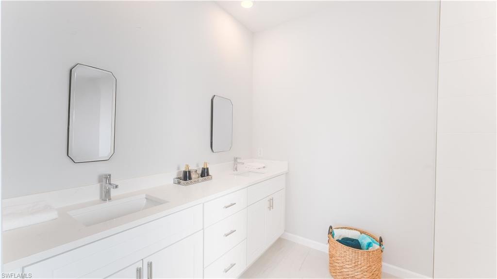 Primary Bathroom with tile patterned flooring and vanity