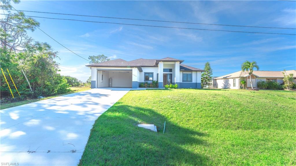 View of front facade with a front yard and a garage