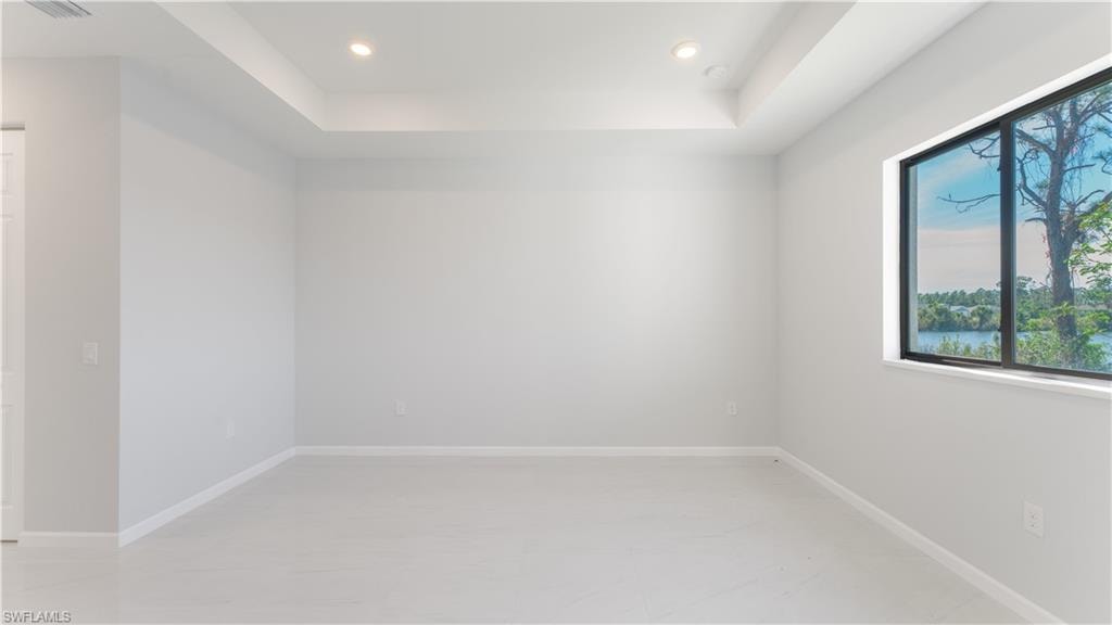Spare room with a tray ceiling