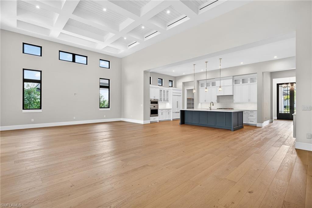 A large open concept in this grand great room with soaring 17 foot ceilings the space is perfect for entertaining and family gatherings