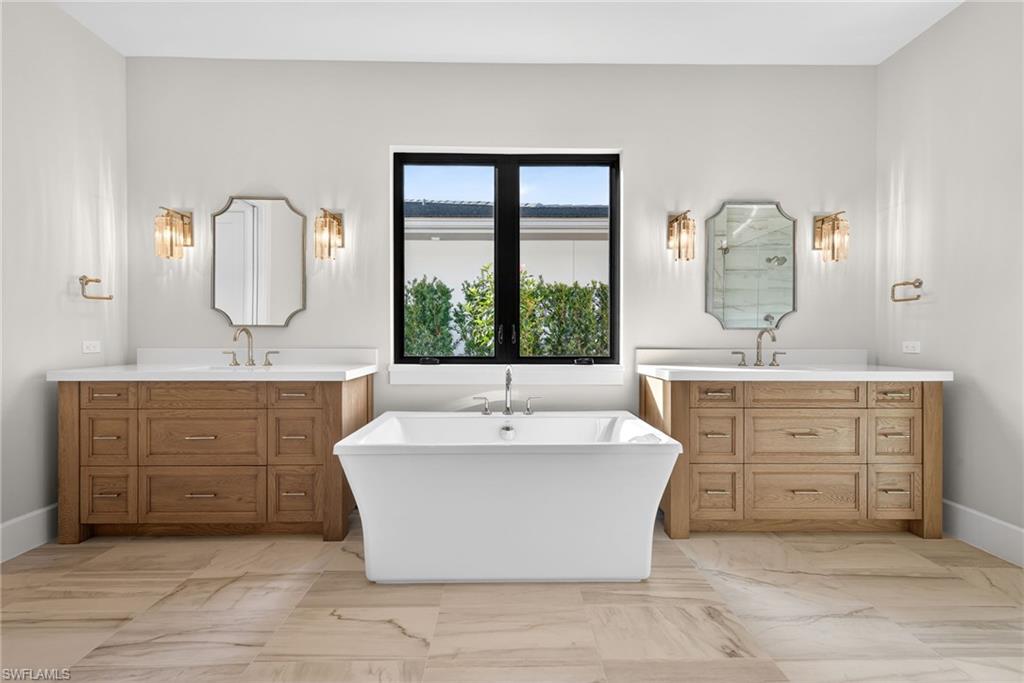 luxurious bathroom with freestanding soaking tub, walk-in shower