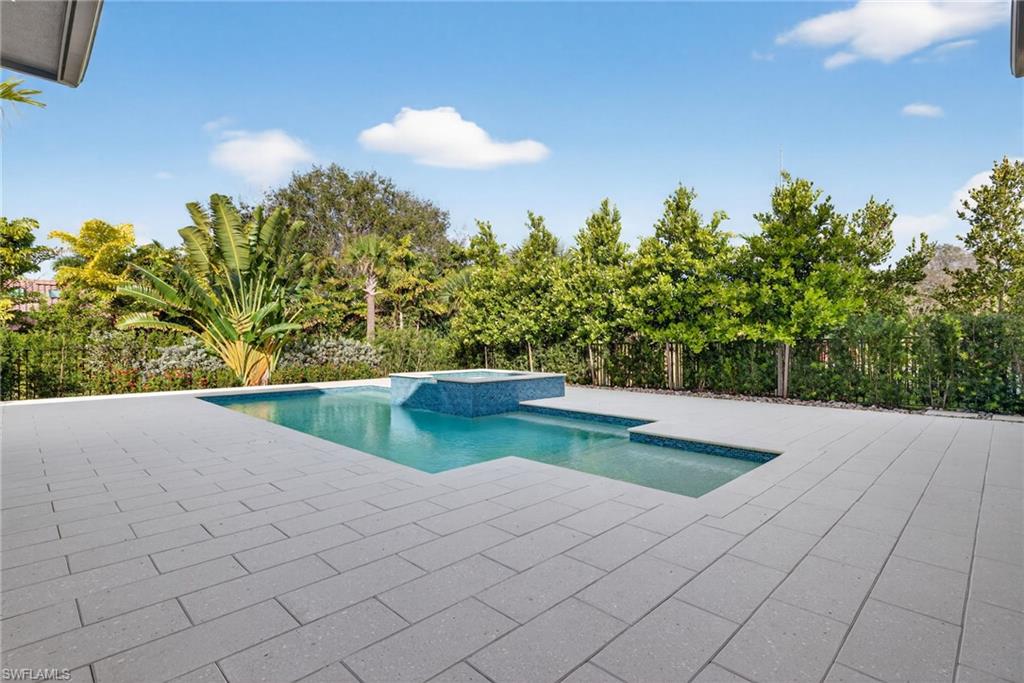 Large patio deck for lounging in or out of the sun, tranquil setting with tropical trees and flowers