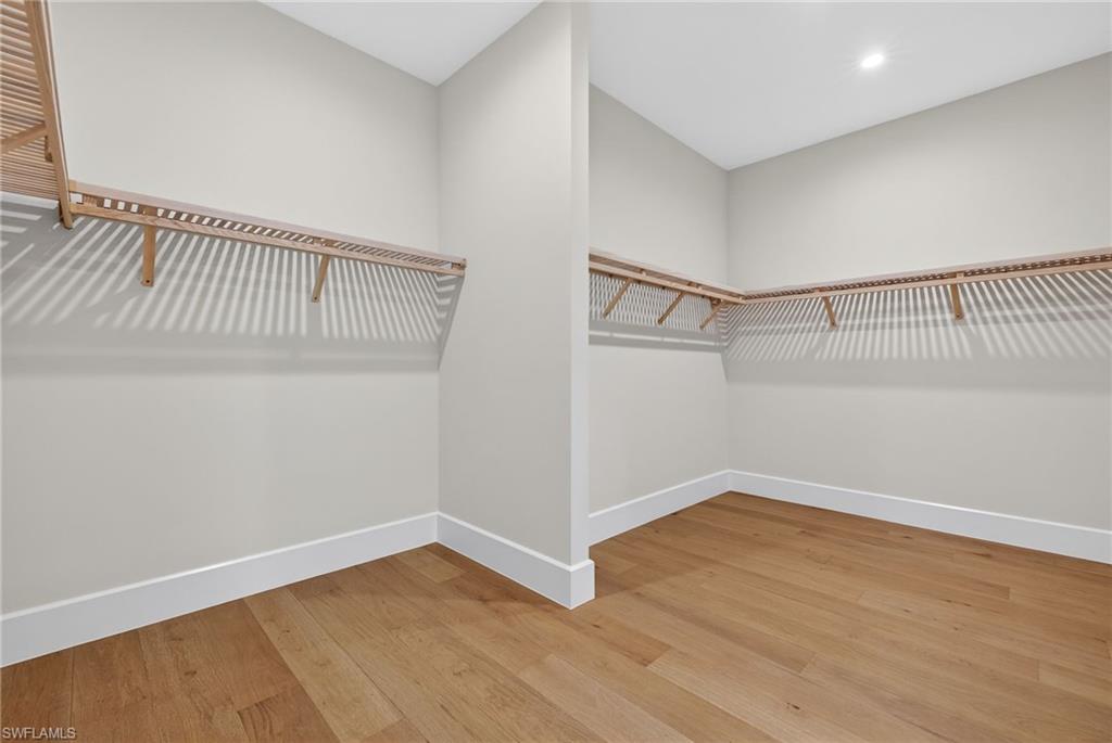 Walk in closet featuring light wood flooring