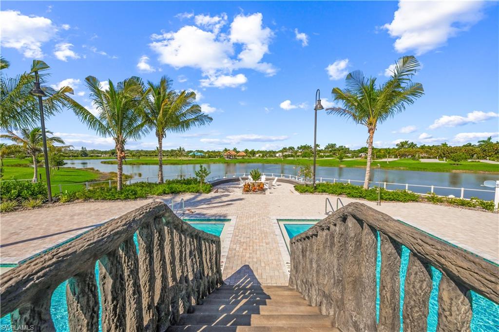 View of pool with a patio area and a water view