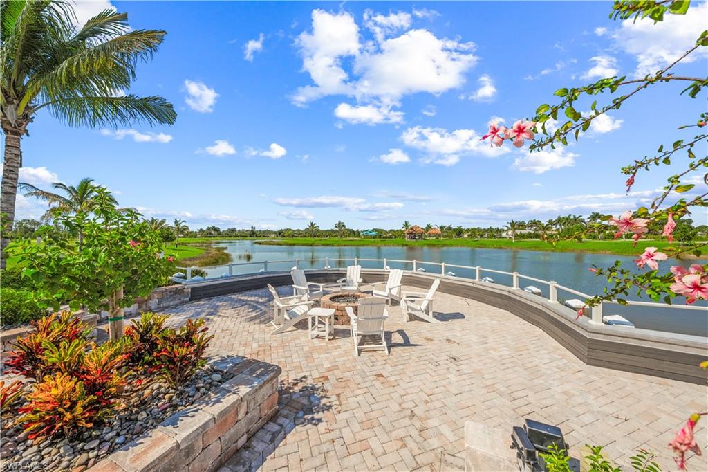View of patio featuring an outdoor fire pit and a water view