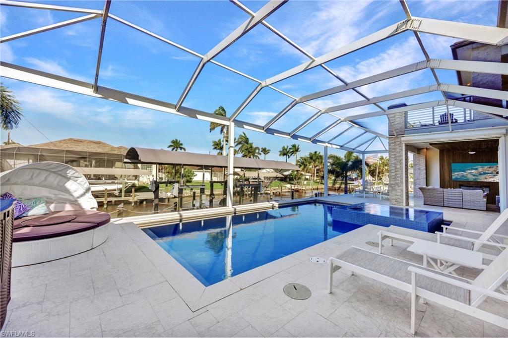 Oversized heated pool/spa area with 1/2 bath & outdoor kitchen