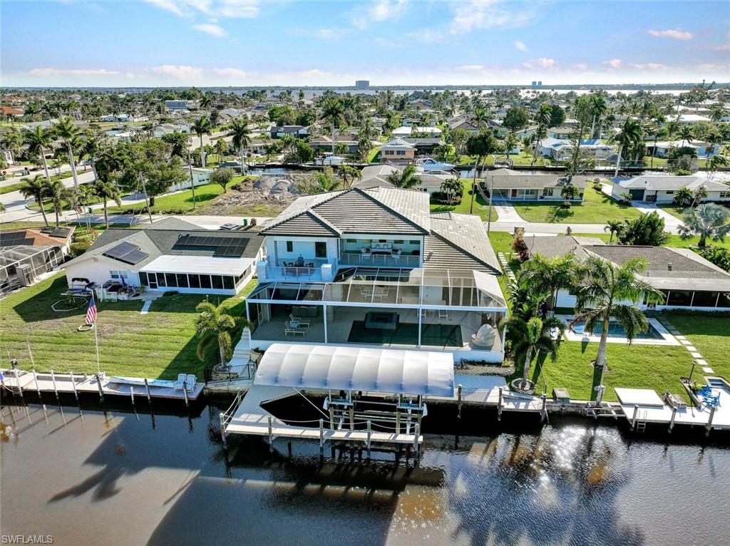 Sailboat access home with covered boat lift