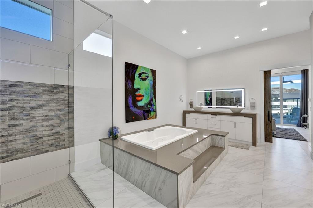 Beautiful master bath with waterfall quartz vanity, porcelain vessel sinks & led mirrors