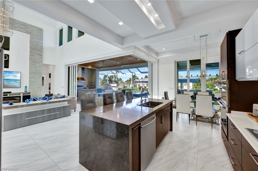 Kitchen features level IV quartz counters w/waterfall edge island, wine cooler & coffee bar
