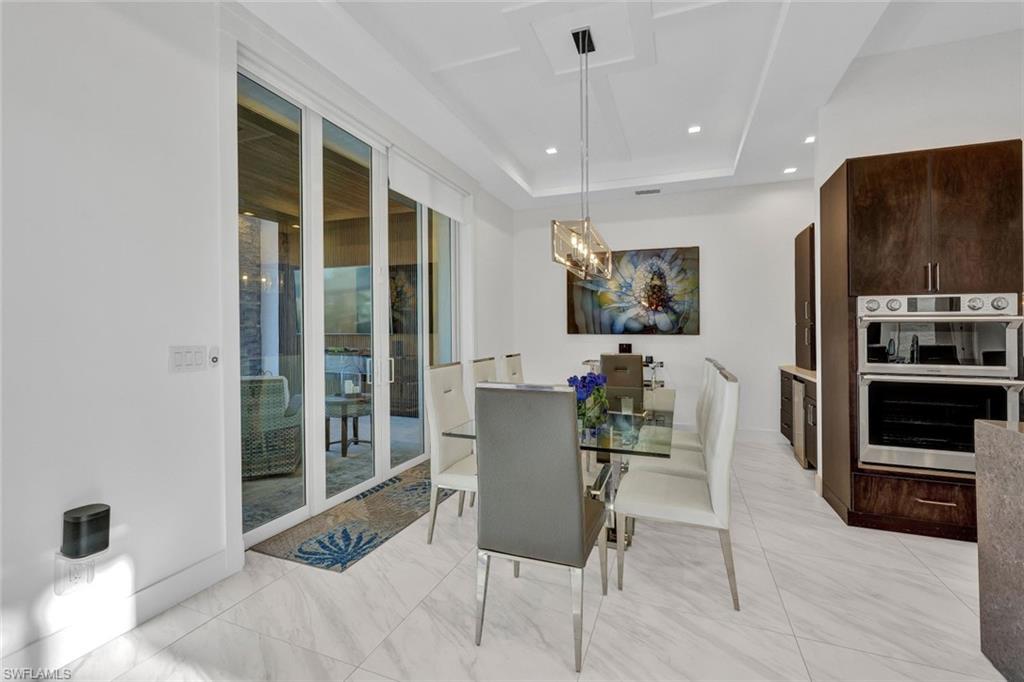 Dining area opens up to the cabana that has a fireplace, TV & 1/2 bath