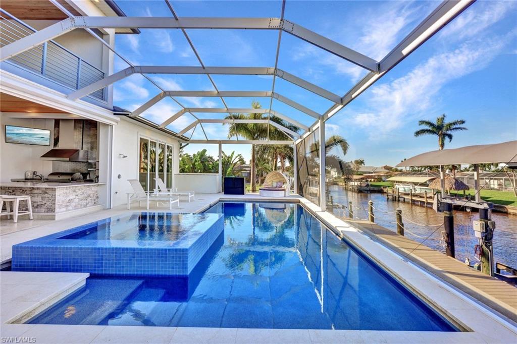 Large heated pool with an integrated spa & an outdoor kitchen