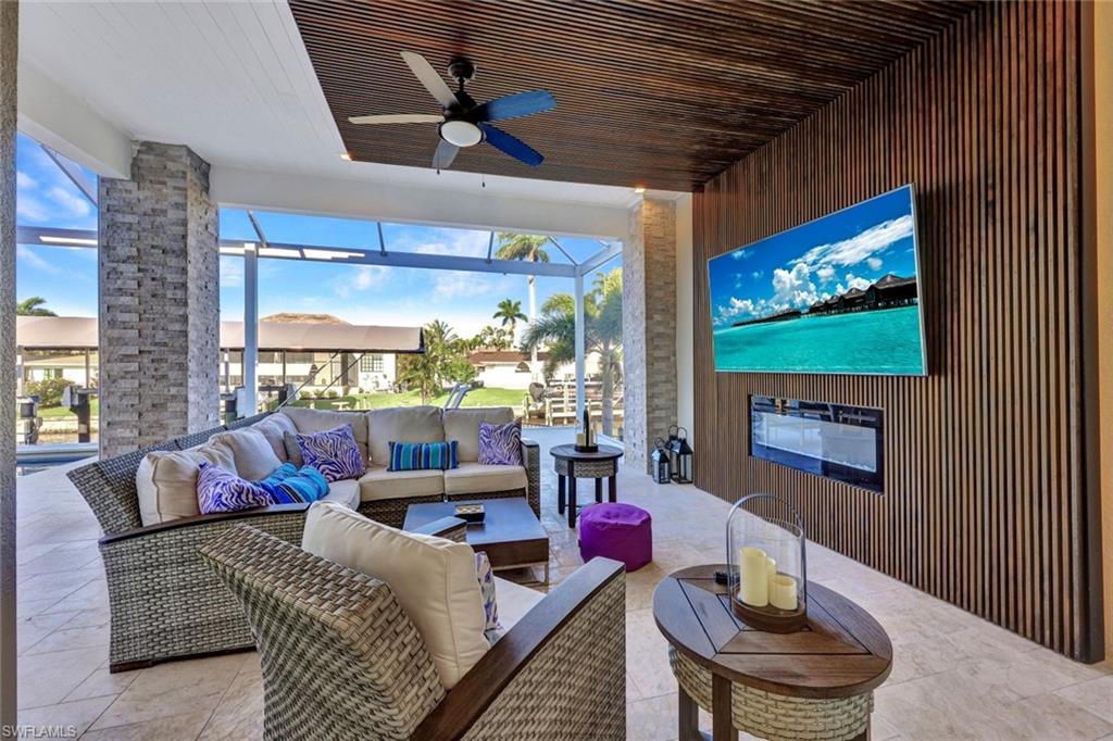 Poolside Cabana area has a 1/2 bath accented with a contemporary wood design, indirect lighting, tv, fireplace & remote controlled hurricane screens.