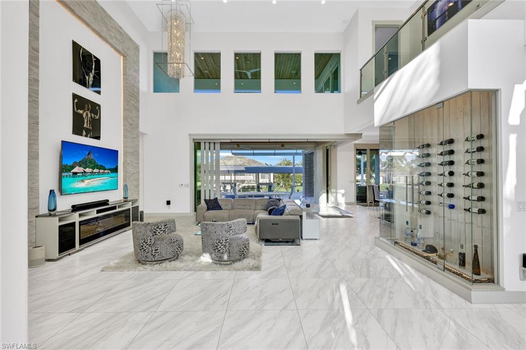 Wow! Check out this living area with 25 ft ceilings that opens up to the large pool/spa area!