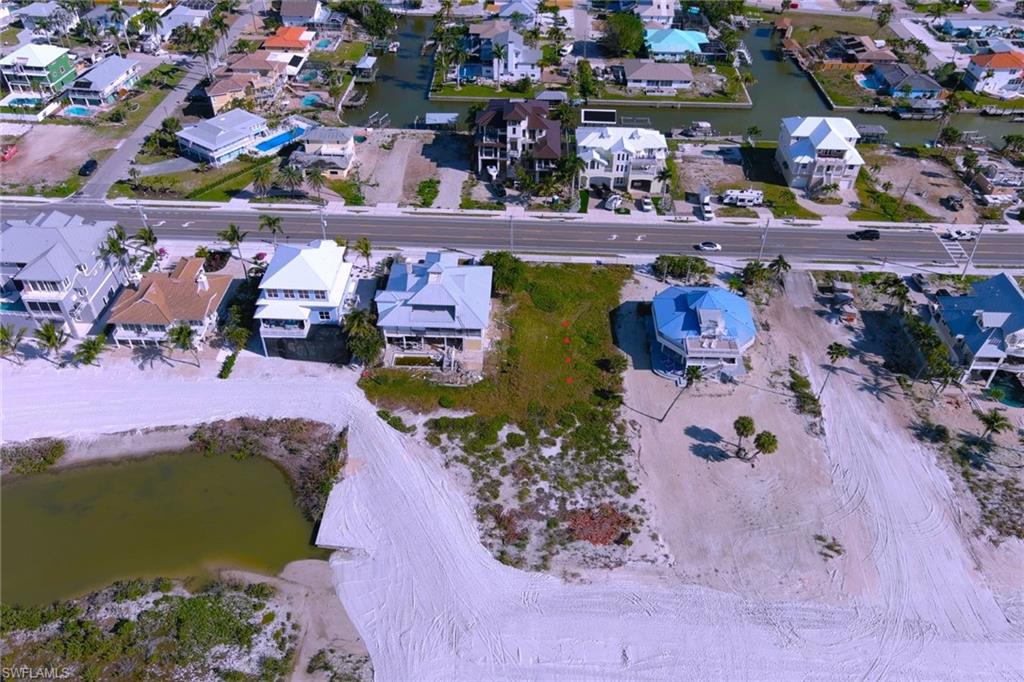 LOT BETWEEN BLUE ROOF AND LIGHT GRAY RED DOTS SHOW LOT THAT GOES OUT TO THE GULF ON SURVEY.