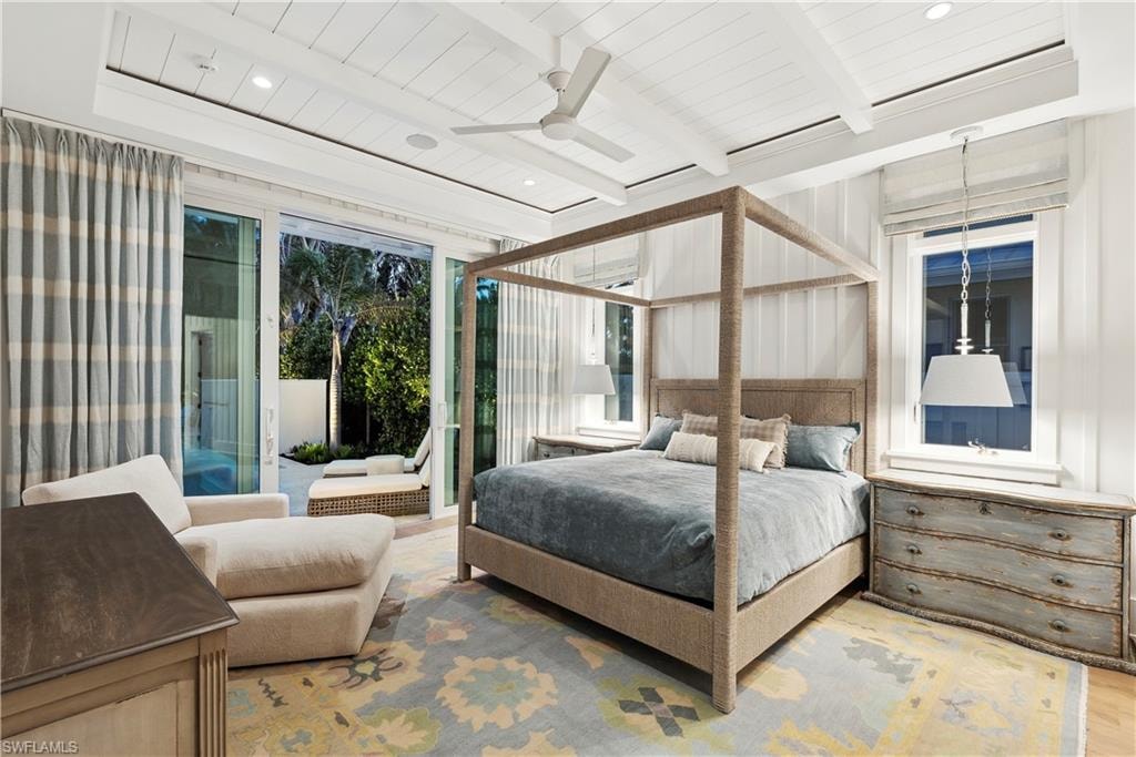 Bedroom featuring beam ceiling, access to outside, ceiling fan, and hardwood / wood-style flooring