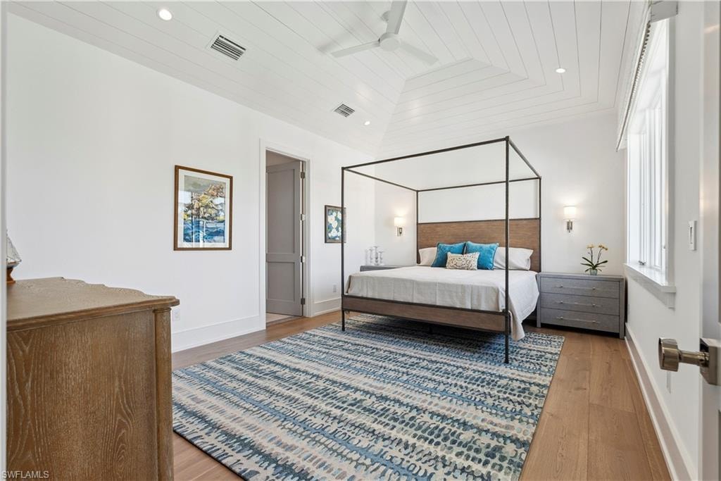 Bedroom featuring vaulted ceiling, wood ceiling, and hardwood / wood-style floors