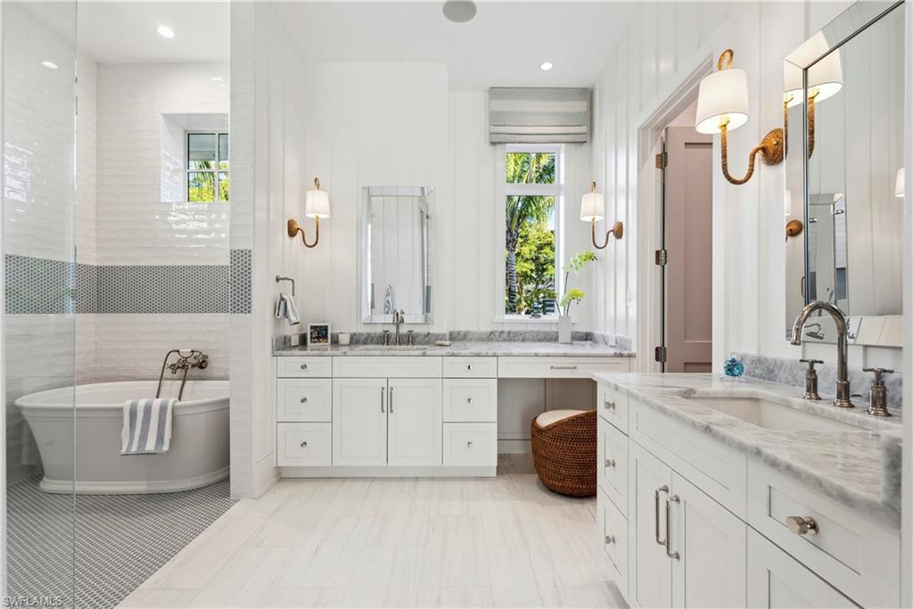 Bathroom with a tub to relax in and vanity