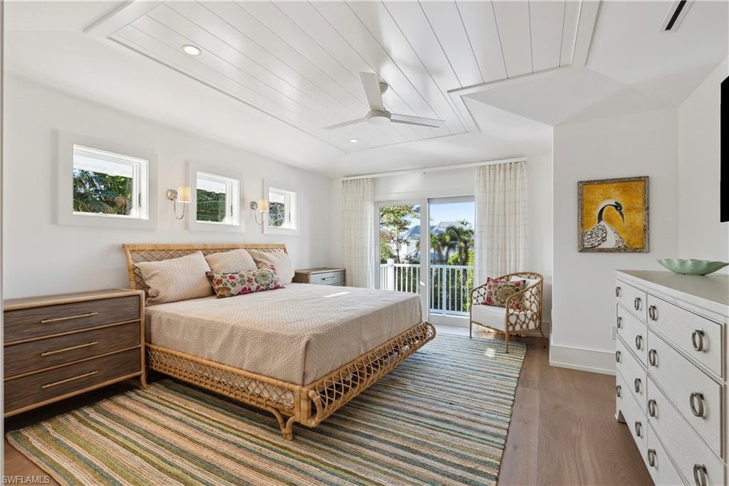 Bedroom with light hardwood / wood-style flooring, access to outside, wooden ceiling, and ceiling fan