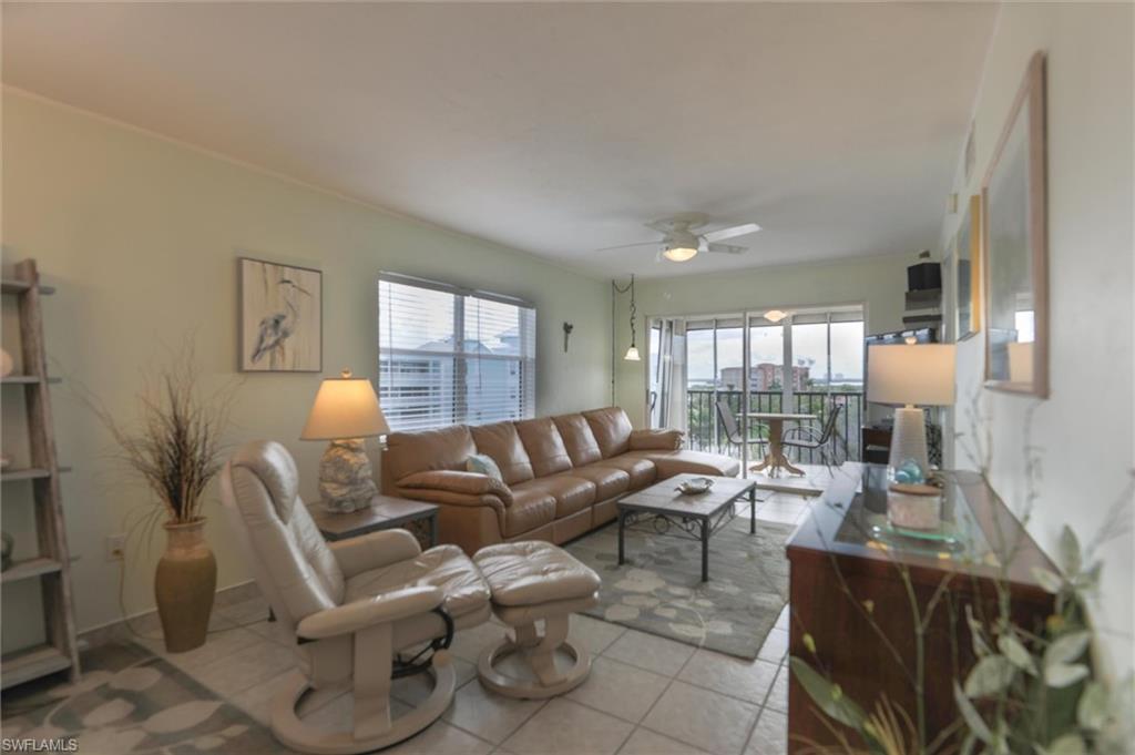 Living room with plenty of natural light, ceiling fan, and light tile floors