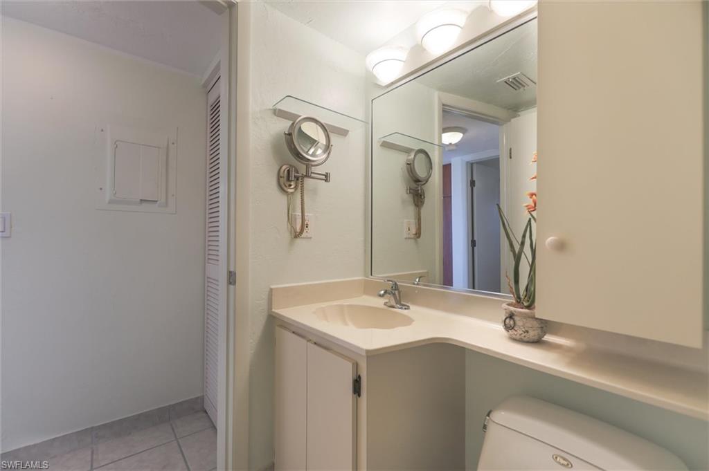 Bathroom featuring vanity, toilet, and tile floors