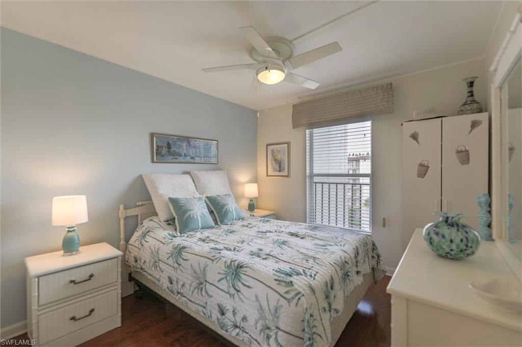 Bedroom with dark hardwood / wood-style floors and ceiling fan