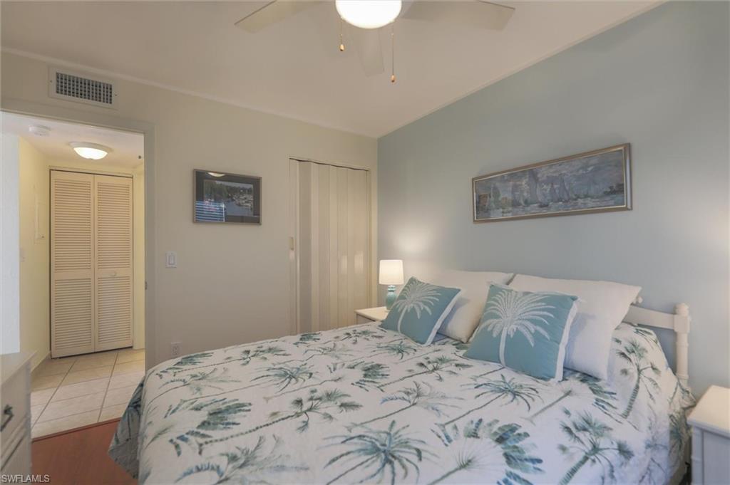Bedroom featuring ceiling fan, a closet, and hardwood / wood-style flooring