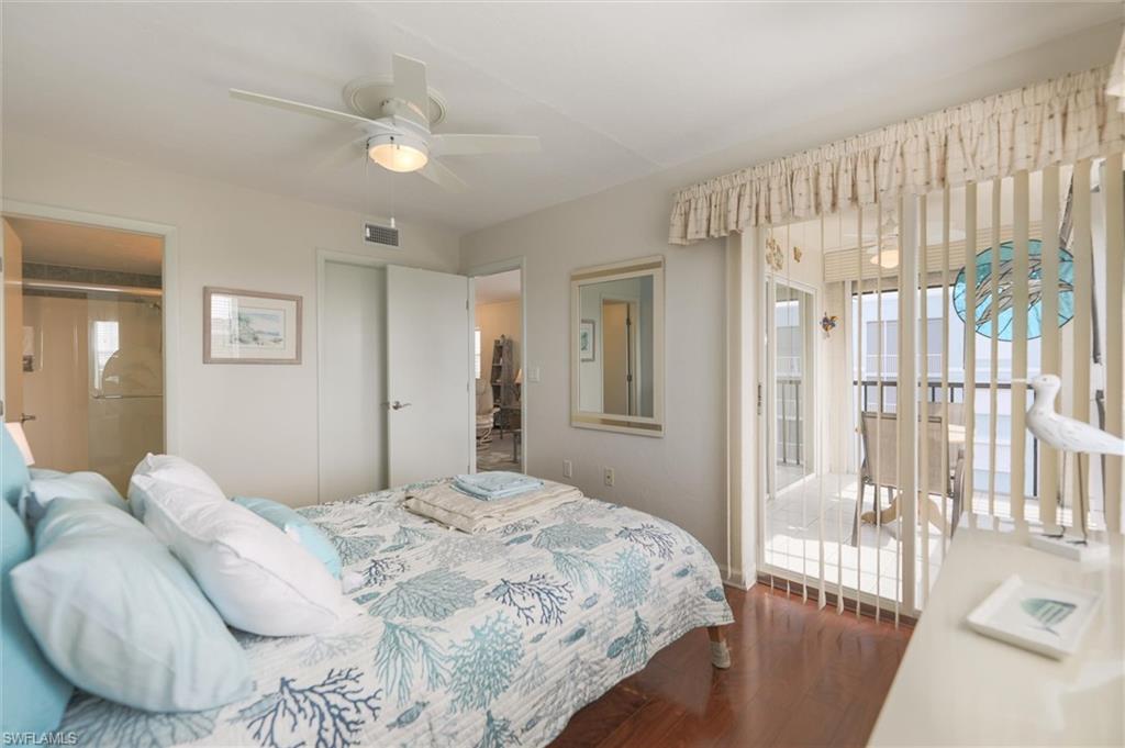 Bedroom featuring hardwood / wood-style flooring, multiple windows, and ceiling fan