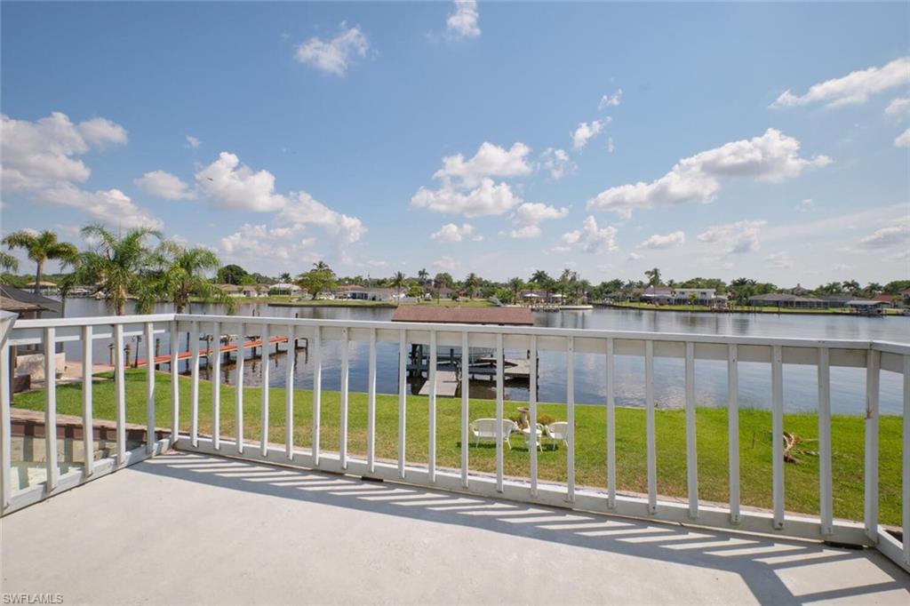 Balcony with a dock and a water view