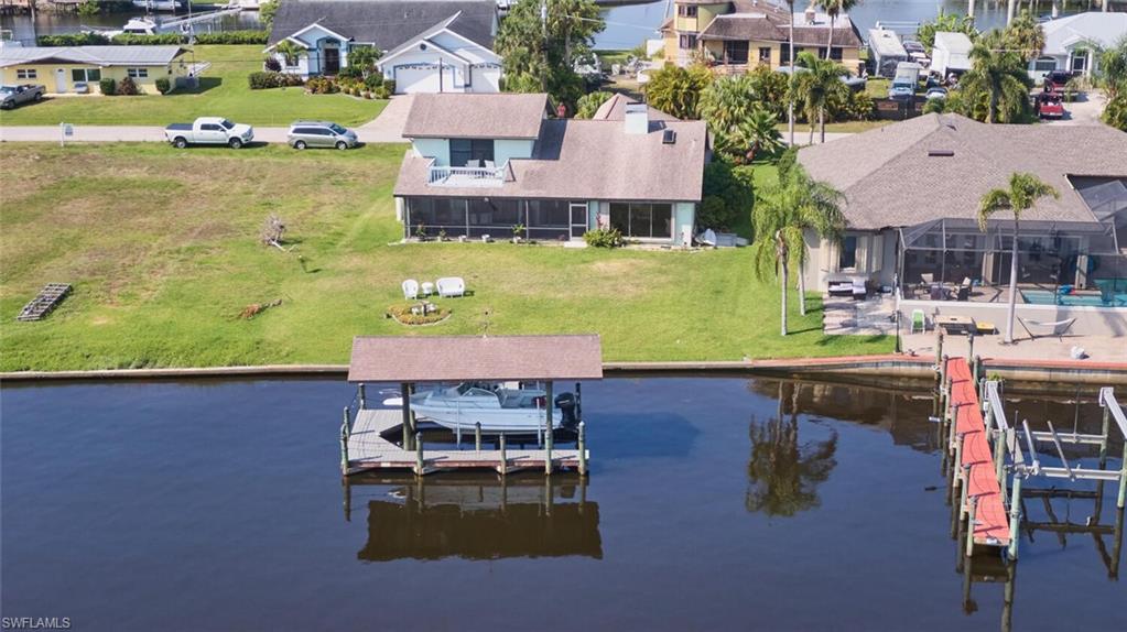 Dock area featuring a water view and a yard