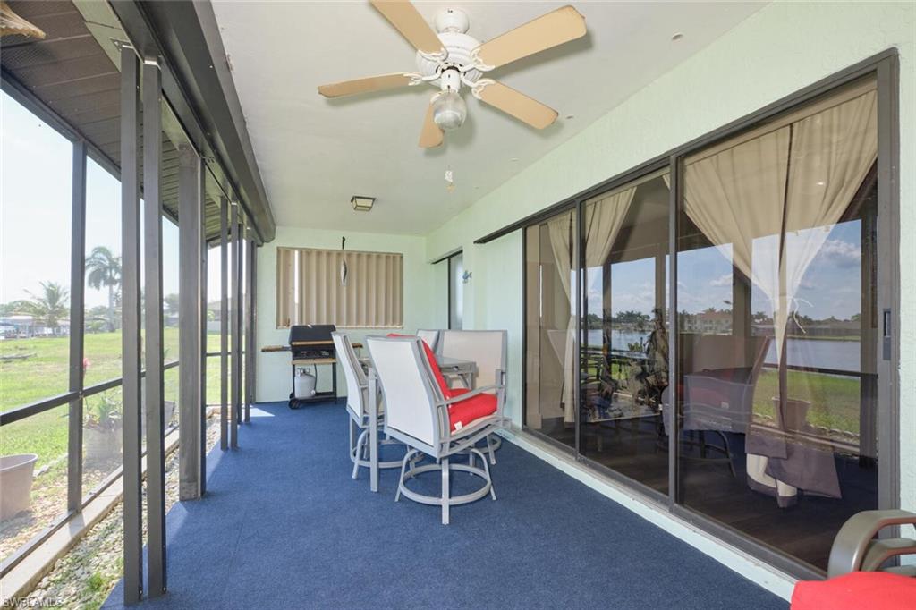 Sunroom / solarium featuring ceiling fan