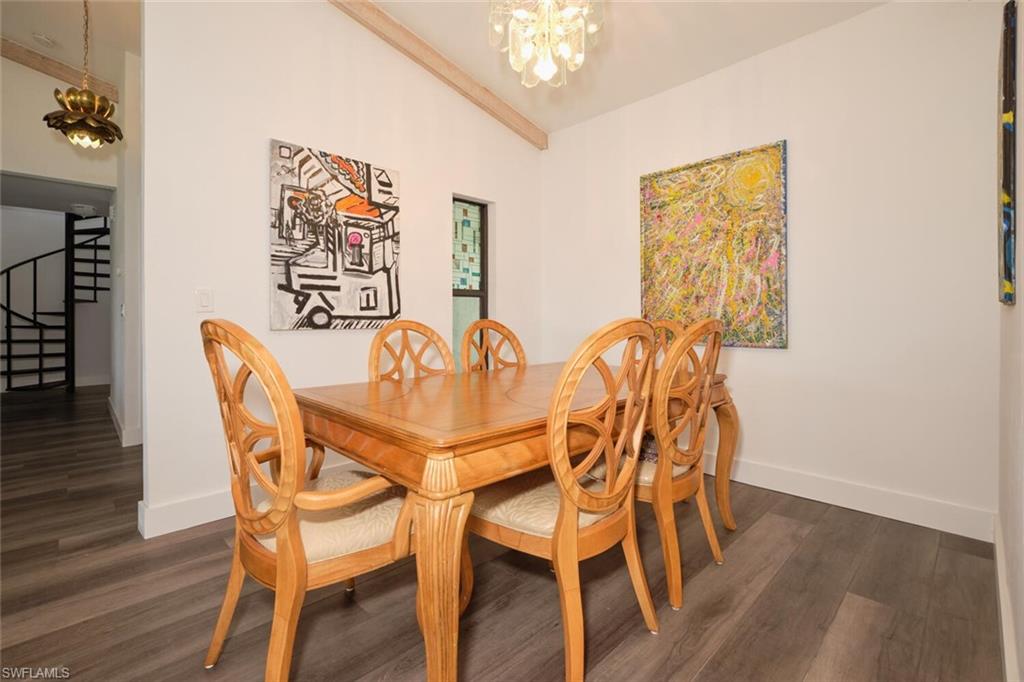 Dining space featuring dark hardwood / wood-style floors and a chandelier